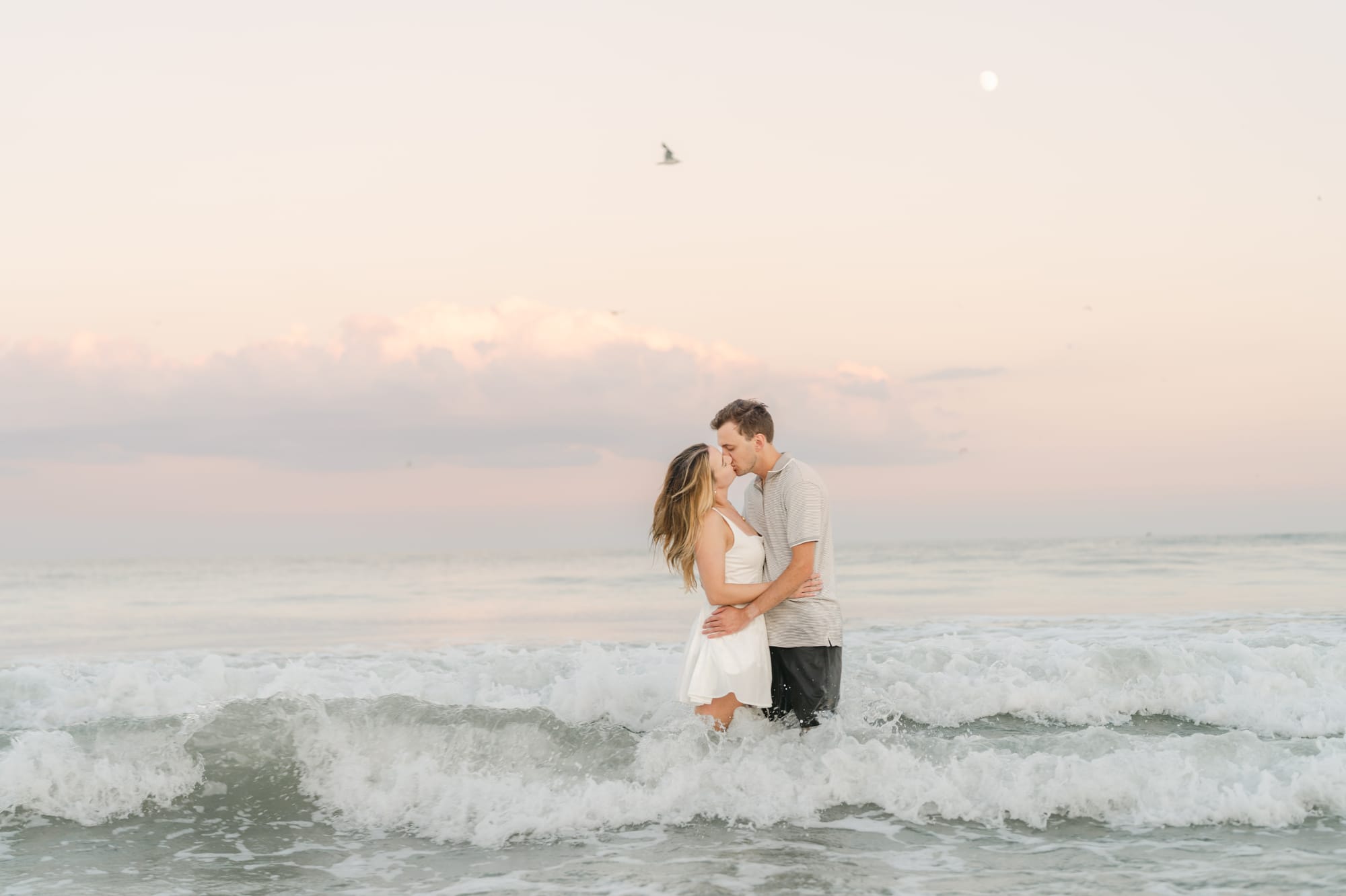 A kiss in the waves at sunrise